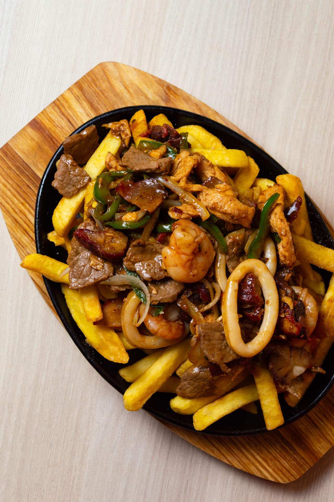 Salteado mixto con papas fritas en plancha de hierro